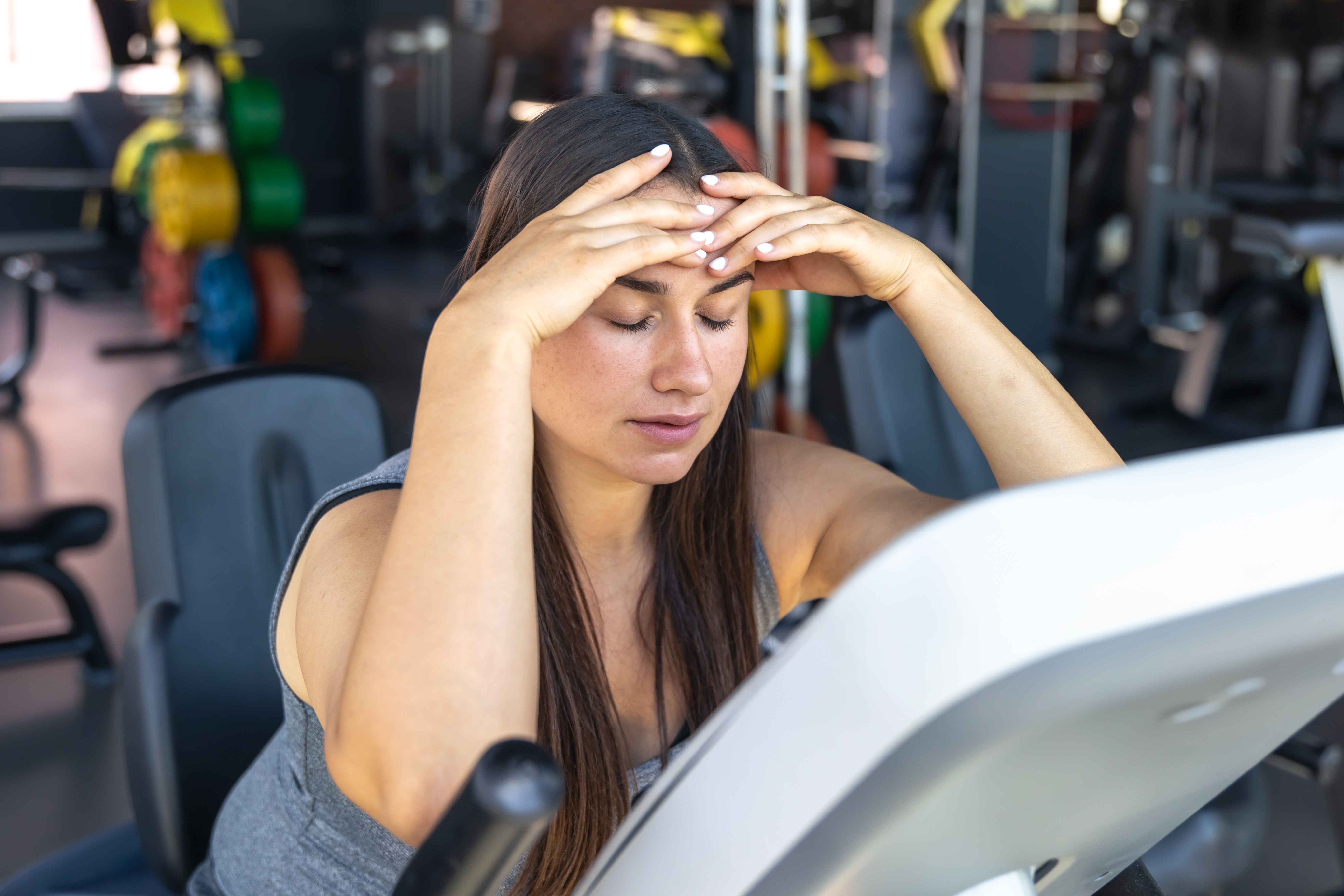 Tired woman on treadmill at the gym